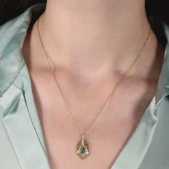Enchanted Disney Fine Jewelry 10K Yellow Gold with 1/8 CTTW Diamonds and Swiss Blue Topaz Jasmine Peacock Feather Pendant Necklace
